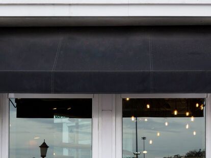 Picture of a black awning over cafe windows